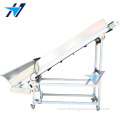 Climbing conveyor with material hopper